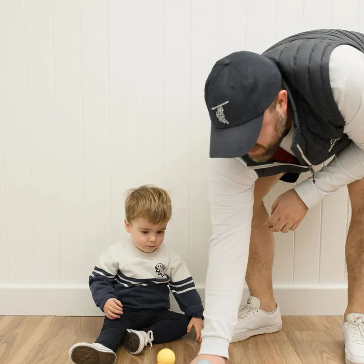 A speech pathologist playing a skittles game with a young child during a session